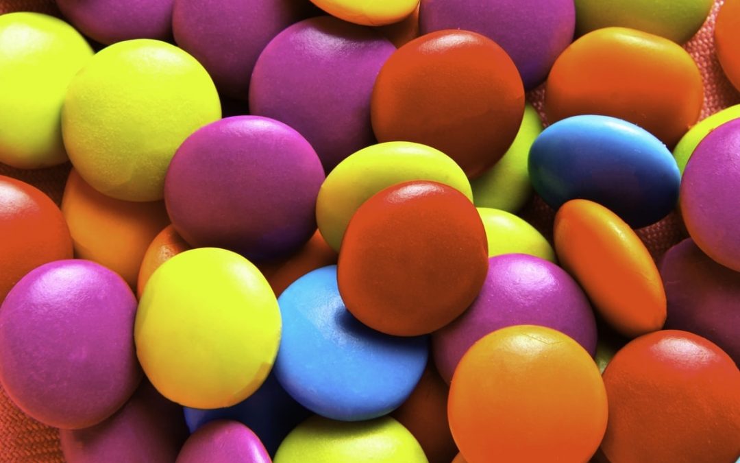 Stock photo of bright candy pieces like m and mims